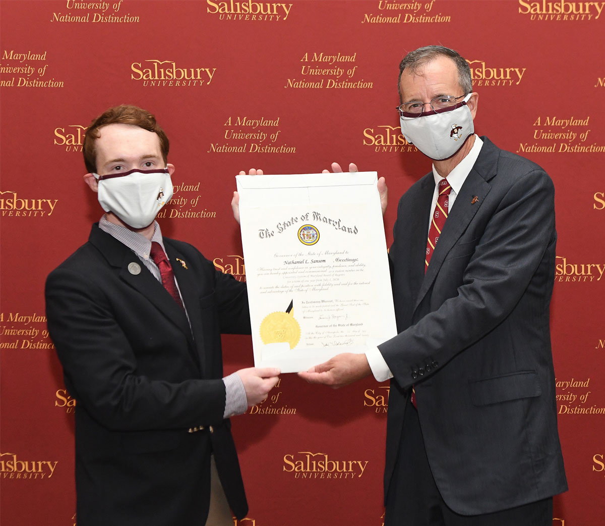 Nate Sansom receiving State citation from SU President Charles Wight